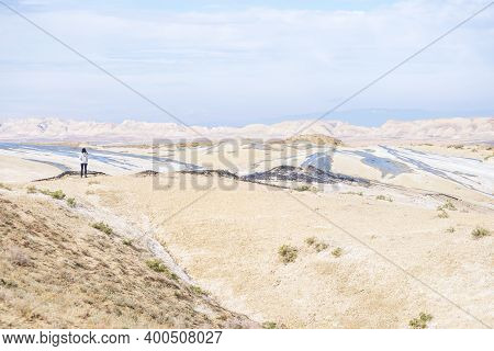 Colorful Mud Volcanoes Panoramic View With Female Person Standing N Chacuna Managed Reseve In Georgi