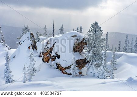Sheregesh Ski Resort In Russia. Winter Landscape, Trees In Snow, Clouds And Big Beautiful Stone Bloc