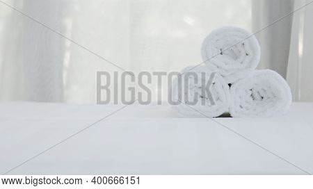 Close Up Oftowel Placed On Basket, White Table Top, Bottle Of Liquid Soap, Spa Set For Bathing In Th