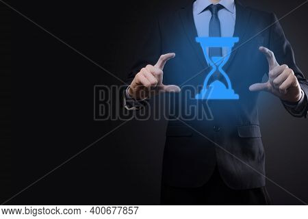 Businessman Man Holds In Hand Hourglasses Icon. Time Expires. A Reminder To Action. Business Concept