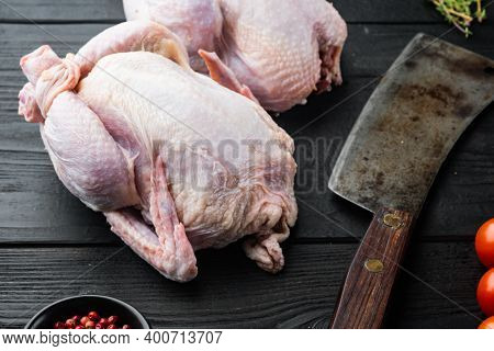 Raw Coquelet Chickens With Herbs Ingredients, On Black Wooden Background
