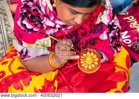 Kolkata, West Bengal, India - 31st December 2018 : Young Bengali Female Artist Painting Pattachitra 