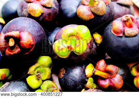 Red Mangosteen And Dark Mangosteen Background In The Market, Mangosteen Isolated On The White Backgr