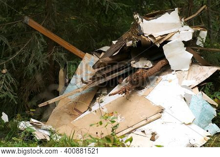 Construction Debris In The Coniferous Forest, Environmental Pollution, Closeup. Garbage, Trash, Rubb