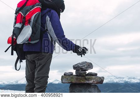 Unknown Hiker With Red Backpack Placing A Mark On The Path To Ascend The Mountain In Winter. Milesto
