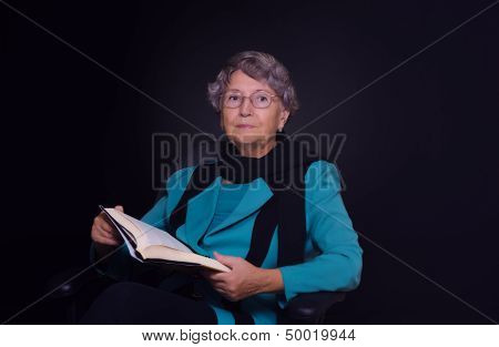 The old lady looked up from reading the book