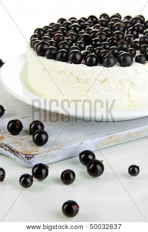 Cheesecake with fresh berries on white plate closeup