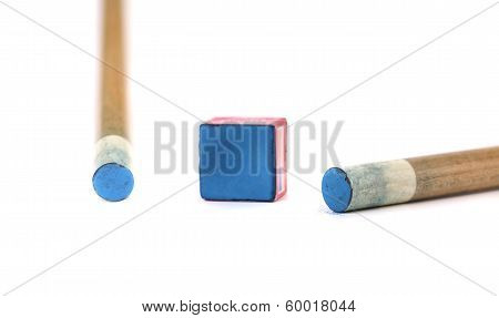 Cue sticks with chalk block.