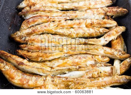Fried Small Smelt Fish On A Barbecue Grill  Hotplate
