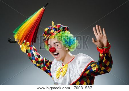 Funny clown with colourful umbrella