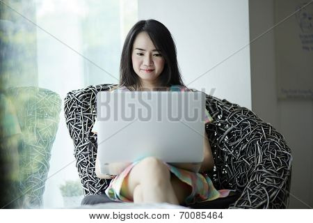 Young Woman Using Laptop Computer In Coffee Shop.