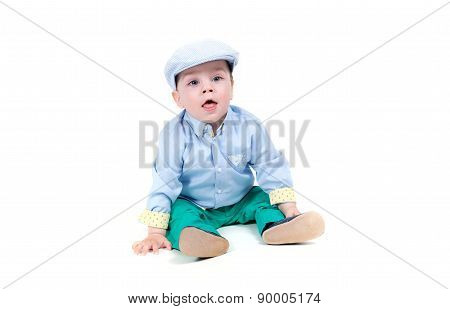Fashionable little baby. Handsome blond baby with big blue eyes. White background
