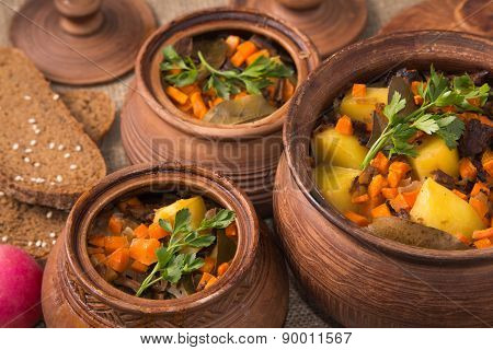 Baked potatoes with mushrooms in pot