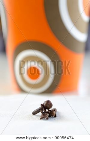 Cloves spices on the background paper coffee cups