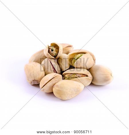Heap of salted pistachio nuts isolated on white background