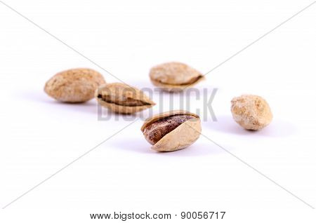 Heap of salted pistachio nuts isolated on white background