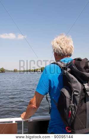 Senior man with backpack in nature landscape