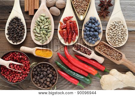 Spices and herbs in metal bowls and wooden spoons. Food and cuisine ingredients