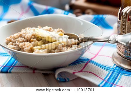 Oatmeal With Butter, Berries And Nuts For Breakfast With Tea