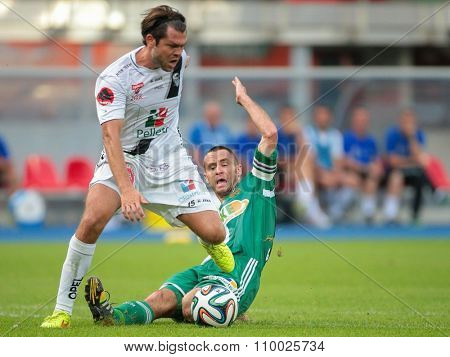 VIENNA, AUSTRIA - SEPTEMBER 20, 2014: Nemanja Rnic (#15 Wolfsberg) and Steffen Hofmann (#11 Rapid) fight for the ball in an Austrian soccer league game.