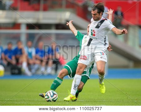 VIENNA, AUSTRIA - SEPTEMBER 20, 2014: Nemanja Rnic (#15 Wolfsberg) and Steffen Hofmann (#11 Rapid) fight for the ball in an Austrian soccer league game.