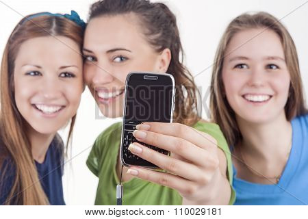 Lifestyle Concept And Ideas. Three Beautiful Caucasian Ladies Taking Selfie Photos With Smartphone.