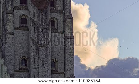 Belltower Of Grundtvig's Church In Copenhagen With Sky And Birds