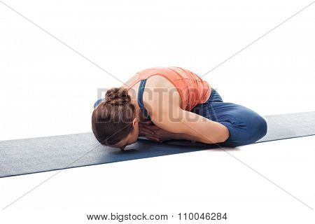 Beautiful sporty fit woman practices yoga asana Baddha konasana - bound angle pose isolated on white