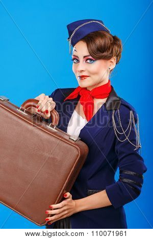 Stewardess With Face Art Holds Suitcase.