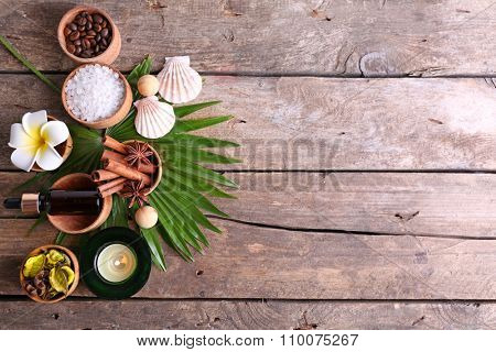 Beautiful spa setting on palm leaf on wooden table