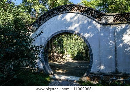 Historic traditional Chinese moon gate of Beijing at sunny day in summer