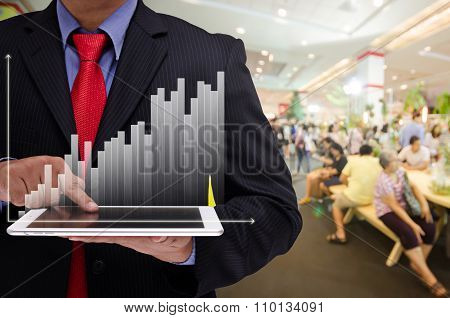 Business Man Holding Tablet With Business Graph Virtual Screen