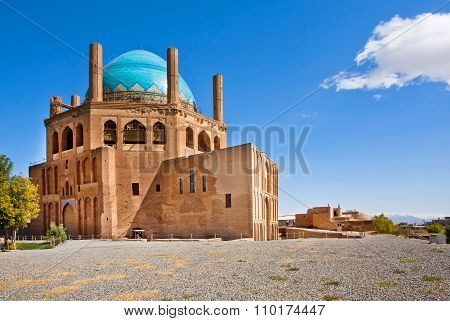 Blue Domed Ancient Building Of Mausoleum Dome Of Soltaniyeh Under The Clear Sky With Cloud. Iran.