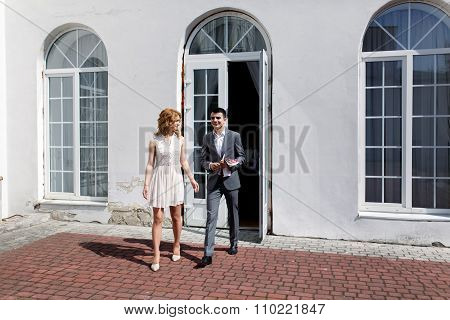 Elegant Blonde Bride And Groom In Expensice Grey Suit Walking Out Of The Registry