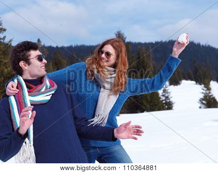romantic winter  scene, happy young couple having fun on fresh show on winter vacatio, mountain nature landscape