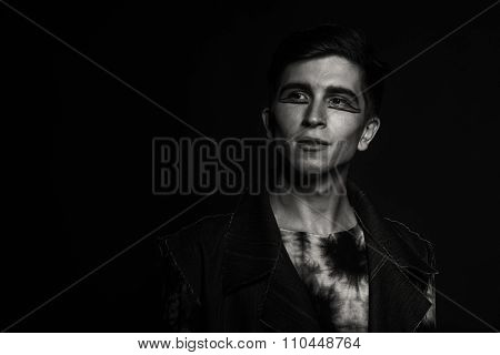 Young, handsome male actor. Actor in theatrical makeup. Emotional game male actor.