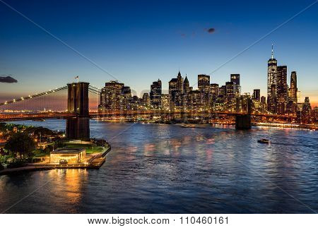 Brooklyn Bridge And Illuminated Manhattan Skyscrapers At Twilight. New York