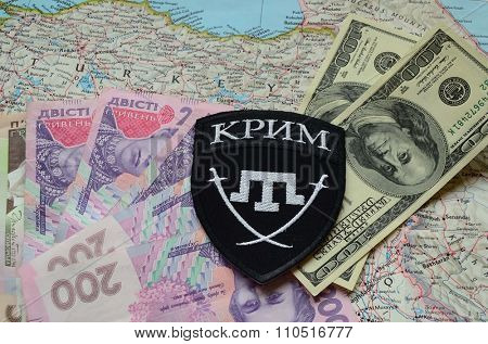 Kiev, Ukraine.NOV 13.Illustrative editorial. Chevron of Islamic extremist formation Crimea as part of Ukrainian Army.Background map and money. November 13, 2015 in Kiev, Ukraine