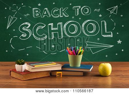 Back to school concepty with writing on blackboard and desk, apple, books, items