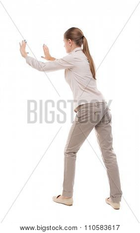 back view of woman pushes wall. Isolated over white background. Rear view people collection. backside view of person. Girl with long hair in a white jacket repelled