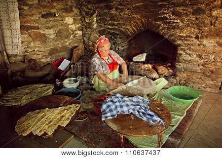 Elderly Woman Cooking Traditional Gozleme Dish Rustic Stone Oven Of Old Turkish Village