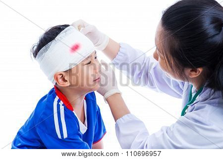 Sports Injury. Doctor Makes A Bandage On Head Patient, On White.