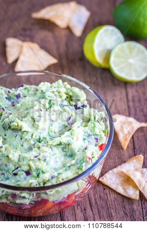 Glass Bowl Of Guacamole With Salsa
