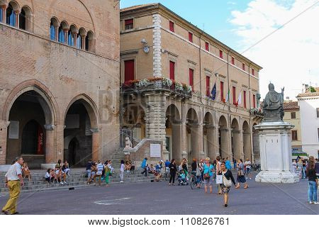 Tourists Walking Near Rimini City Hall And Statue Of Pope Paul V On Cavour Square In Rimini, Italy