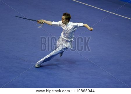 JAKARTA, INDONESIA: NOVEMBER 14, 2015: Peter Hlawaty from Slovakia performs the movements in the men's Jianshu event at the 13th World Wushu Championship 2015 held at Istora Senayan, Jakarta.