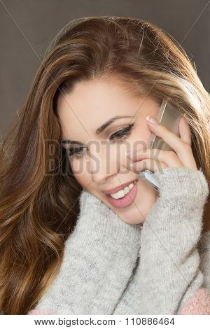 The Young Woman Speaks By The Mobile Phone