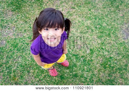 cute asian kid smile on green
