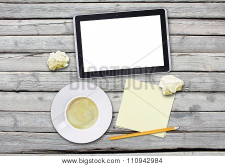 Tablet with blank screen and cup of coffee