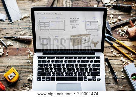Closeup of computer notebook showing wooden furniture sketch plan