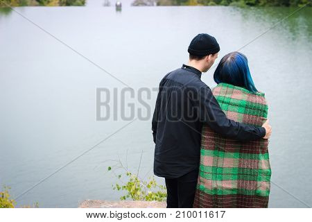 Couple In A Plaid Hugging On The Lake Shore